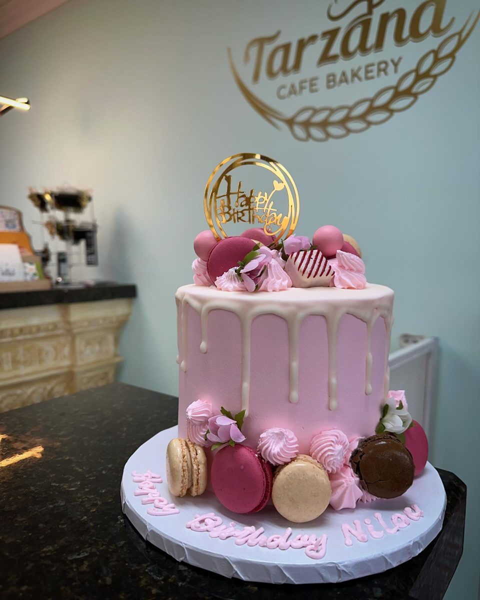Pink Drip Cake With Macaron Decorations from Tarzana Bakery