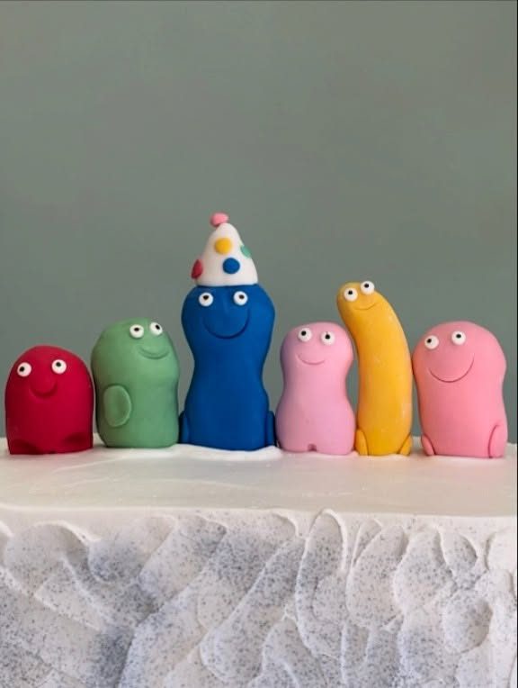 White Cake With Colorful Smiling Figures from Tarzana Bakery